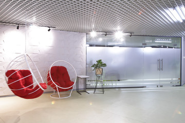 Interior of the staff rest room in the modern office of the business center. Round chair-swing for...