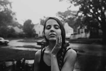 Black and White Portrait of A Woman With Her Eyes Closed Standing in the Rain