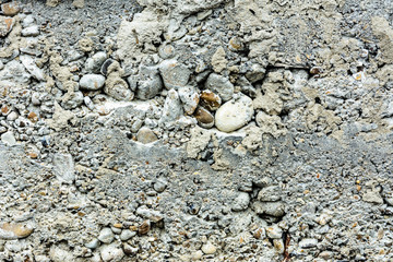 Wonderful background of gray concrete with a textured stone on the foundation