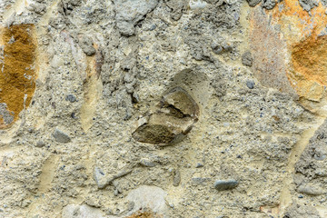 Wonderful background of gray concrete with a textured stone on the foundation