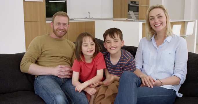 Young family have skype conversation in contemporary moern home in slow motion