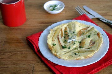 Delicate omelette with potatoes and dill, sprinkled with butter