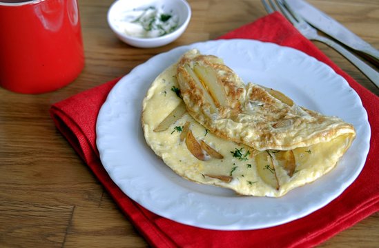 Delicate omelette with potatoes and dill, sprinkled with butter