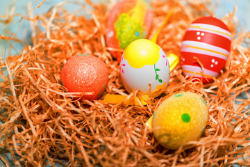 Fototapeta na wymiar Several colorful Easter eggs in nest close