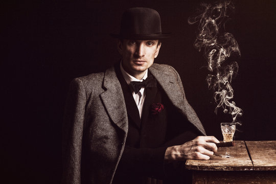 Elegant man at the restaurant table, with a cigar