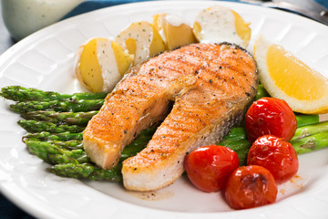 Grilled salmon with green asparagus, cherry tomato and potatoes