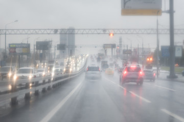 Fototapeta na wymiar car in rain on asphalt wet road. Gray Clouds on the sky .