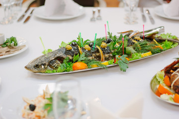 Big fish on table during catering event. Catering buffet.