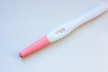 Negative pregnancy test on white table.