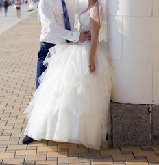 Fototapeta na wymiar Happy bride and groom at wedding walk in park