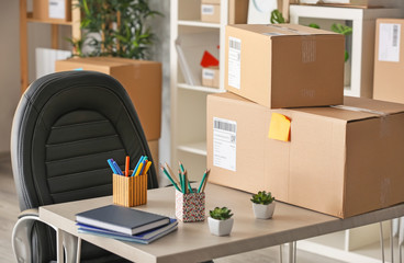 Parcels ready for shipment to client on table in home office