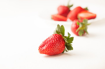Ripe red strawberry on white table