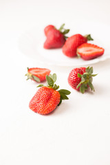 Ripe red strawberry on white table