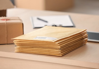 Parcel envelopes ready for shipment to client on table in home office