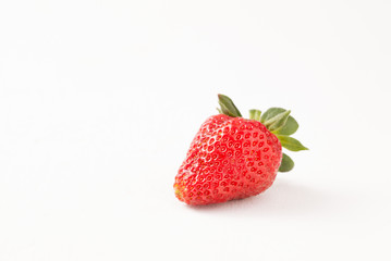 Ripe red strawberry on white table