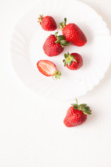 Ripe red strawberry on white table