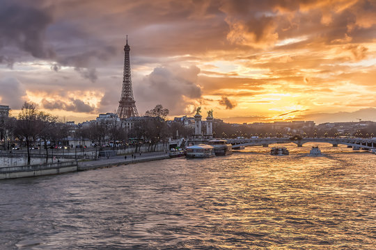 Amazing sunset in Paris, with Seine river and Eiffel tower