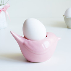 White Easter Egg in Pink Egg Stand