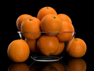 Glass vase, filled with orange fruit