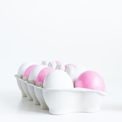 Pink and white Easter eggs in craft egg stand
