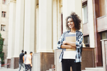 African-american student with books at university