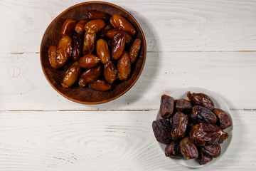 Dried dates fruit on white wooden table. Top view