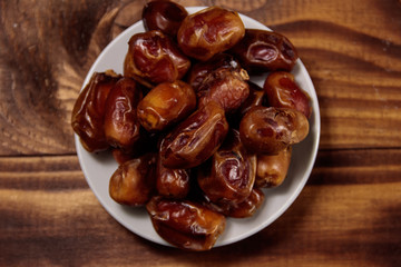 Dried dates fruit on wooden table. Top view
