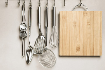 Kitchen interior, utensils for cooking hanging with hooks on the wall