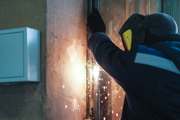 the welder welds metal structures