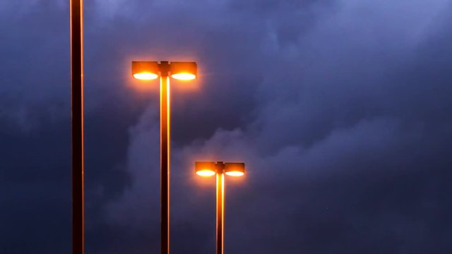 Parking lot lights and dark clouds - time lapse
