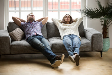 Young couple relaxing having nap or breathing fresh air, relaxed man and woman enjoying rest on...