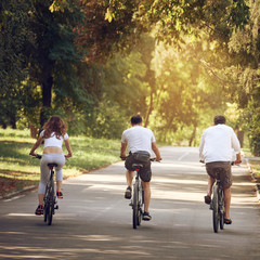 Young healthy people having summer holiday and riding bikes, image with toning square aspect ratio