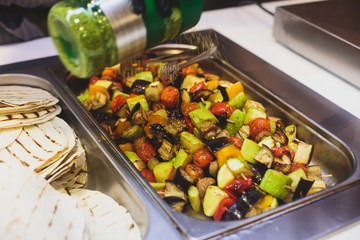 Beautifully decorated catering banquet table with different main course hot food dishes and garnish, with rice, chicken, lamb, vegetables and kebab on corporate party event or wedding celebration