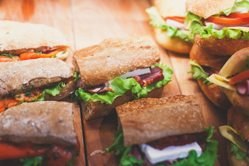 Beautifully decorated catering banquet table with different food snacks and appetizers with sandwich, on corporate christmas birthday kids party event or wedding celebration