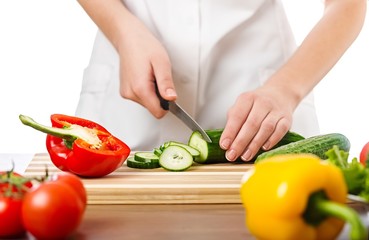 Chef woman cutting cucumber
