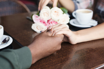 Obraz na płótnie Canvas Couple in love at restaurant, closeup of hands
