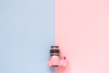 Small photo camera model on pastel background minimalistic concept.