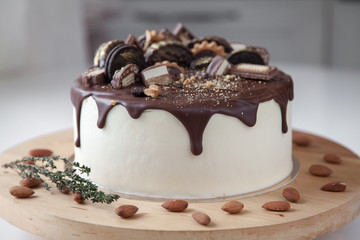 An original chocolate cake, on top of which are various sweets.