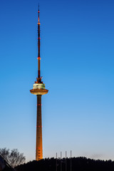 Fototapeta premium Vilnius TV Tower -- the tallest structure in Lithuania -- at night on the clear blue sky background