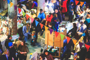 Christmas Market Interior with New Year decorations and multicolored flags
