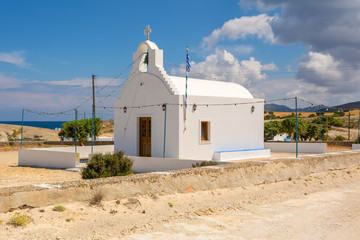 Traditional Greek whitewashed church in Agios Konstantinos on the island of Milos. Cyclades, Greece. © vivoo