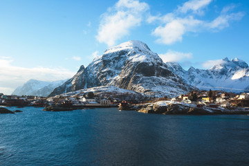 Naklejka premium Beautiful super wide-angle winter snowy view of fishing village A, Norway, Lofoten Islands, with skyline, mountains, famous fishing village with red fishing cabins, Moskenesoya, Nordland