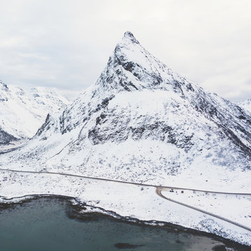 Aerial winter view of Lofoten Islands, Nordland, Norway, with fjord, road, bridge and mountains, shot from drone