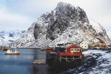 Papier Peint photo Reinefjorden Beautiful super wide-angle winter snowy view of Reine, Norway, Lofoten Islands, with skyline, mountains, famous fishing village with red fishing cabins, Moskenesoya, Nordland