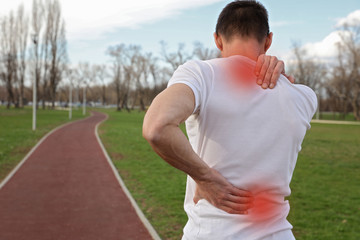 Naklejka premium Sport injury, Man with back pain. Pain relief and health care concept.