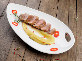 Restaurant dish. Duck fillet with apple sauce..