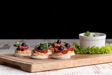 Canapes with salami and olives