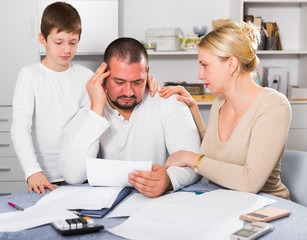 Wife with son comforting upset man