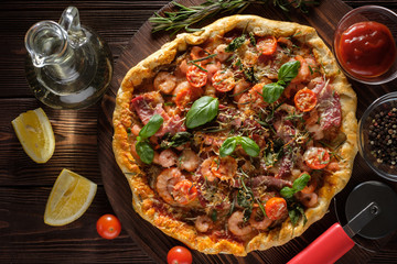 Delicious homemade fresh pizza with shrimps and bacon. Top view