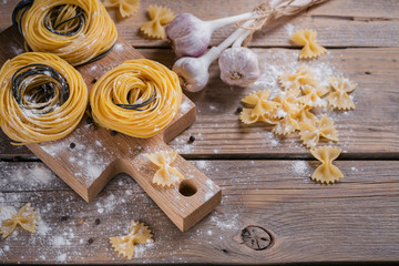 Raw homemade pasta with flour, garlic and spices